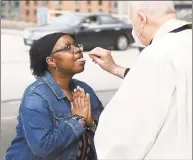  ?? Tyler Sizemore / Hearst Connecticu­t Media ?? The Rev. Albert Audette delivers the Eucharist on the top of the Bell Street Garage across from the Basilica of Saint John the Evangelist in Stamford on May 24.