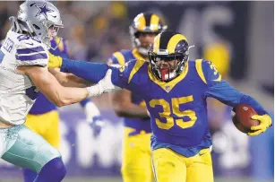  ?? SEAN M. HAFFEY/GETTY IMAGES ?? Los Angeles’ C.J. Anderson runs past Dallas’ Leighton Vander Esch during Saturday’s game. Anderson rushed for 123 yards and two touchdowns in the Rams’ victory.