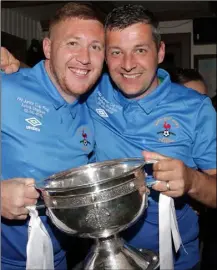  ??  ?? The Murphy brothers, team captain Paul and Jason, with the spoils of success at the North End celebratio­ns in Jim McGee’s pub, John Street, on Saturday night.