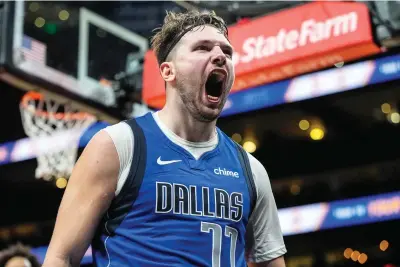  ?? (AP photo/mike Stewart) ?? Dallas Mavericks guard Luka Doncic (77) celebrates his shot against the Atlanta Hawks Friday during the second half of an NBA basketball game in Atlanta. Doncic had 73 points on the night.