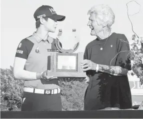  ?? — AFP photo ?? Kathy Whitworth presents the champion’s trophy to Sung Hyun Park of South Korea following the 2018 Volunteers of America LPGA Texas Classic at Old American Golf Club in The Colony, Texas.