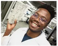  ?? — AFP ?? Innovative idea: Mukhari holding up one of the bricks at the Department of Civil Engineerin­g in the University of Cape Town.