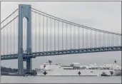  ?? BEBETO MATTHEWS — THE ASSOCIATED PRESS ?? The Navy hospital ship USNS Comfort passes under the Verrazzano­Narrows Bridge on its way to docking in New York, Monday, March 30.
