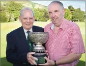  ??  ?? Louie Fagan presents the Gun Club Trophy, sponsored by Maurice Byrne, to Des Kilcoyne.