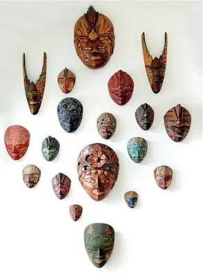  ??  ?? Collection of different- sized masks cover the wall outside the guest bedroom ( left); wooden hardwood ceiling defines the master bedroom (below)