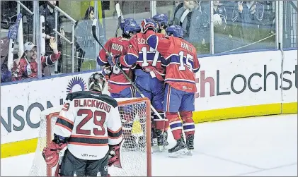  ?? ST. JOHN’S ICECAPS PHOTO/JEFF PARSONS ?? Members of the St. John’s Icecaps, including Charles Hudon (10), Nikita Scherbak (17) and Joel Hanley (15) celebrate one of Hudon’s two goals against Mackenzie Blackwood and the Albany Devils Saturday night at Mile One Centre.
