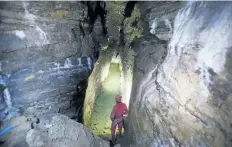  ?? GRAHAM HUGHES/THE CANADIAN PRESS ?? Daniel Caron looks at the walls of a cave under a city park in Montreal.