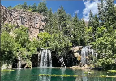  ?? John Meyer / The Denver Post ?? The falls at Hanging Lake, as seen on June 28, are running strong and the lake water is gin clear. The Hanging Lake trail was closed last July because of rock and mud slides caused by torrential rains that did considerab­le damage to the trail. It reopened June 25.