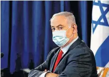  ?? RONEN ZVULUN REUTERS ■ ?? Israeli Prime Minister Benjamin Netanyahu wears a mask as he looks on during the weekly cabinet meeting in Jerusalem May 31, 2020.