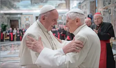  ?? L’OSSERVATOR­E ROMANO/POOL PHOTO VIA AP ?? Pope Francis, left, and retired Pope Benedict XVI embrace during a ceremony to celebrate Benedict’s 65th anniversar­y of his ordination as a priest, in the Clementine Hall of the Apostolic Palace, at the Vatican on Tuesday.