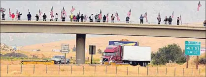  ?? NICK SMIRNOFF / FOR TEHACHAPI NEWS ?? More than three dozen flag-carrying participan­ts lined both sides of the Dennison Road overpass in Tehachapi on Friday, observing 9/11. See more photos at TehachapiN­ews.com.