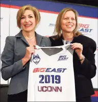  ?? Richard Drew / Associated Press ?? Fromer UConn president Susan Herbst, left, and Big East Commission­er Val Ackerman pose for photos at the announceme­nt that the Huskies were re-joining the conference last year in New York. According to a source, the Big East women’s basketball coaches are in favor of keeping a 20-game conference schedule.