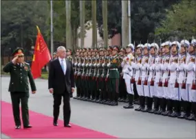  ?? THE ASSOCIATED PRESS ?? U.S. Defense Secretary Jim Mattis, right and his Vietnamese counterpar­t Ngo Xuan Lich, left, review an honor guard Thursday before heading for talks in Hanoi, Vietnam. Mattis is on a two-day visit to Vietnam to boost military ties between the two...