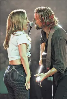  ??  ?? Lovers walk: Bradley Cooper and Lady Gaga, above, as Jackson Maine and Ally in the latest remake of A Star Is Born