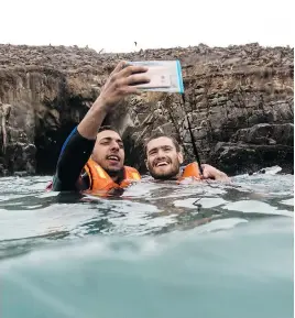  ?? THE ASSOCIATED PRESS ?? Many tourists swim a short distance away from the giant sea lions and take selfies near the rocks on the Palomino Islands, off the coast of Lima, Peru.
