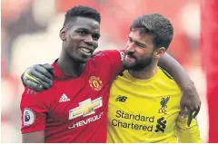  ?? REUTERS ?? United’s Paul Pogba, left, and Liverpool’s Alisson after a match.