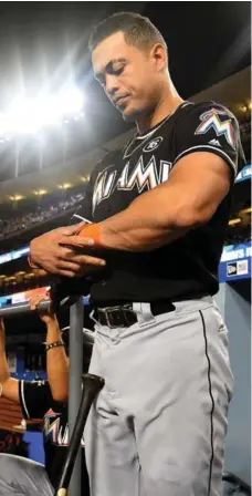  ?? JAYNE KAMIN-ONCEA/GETTY IMAGES ?? National League MVP Giancarlo Stanton hit 59 home runs last season, but his 13-year, $325 million contract led the Marlins to seek a trade for him.