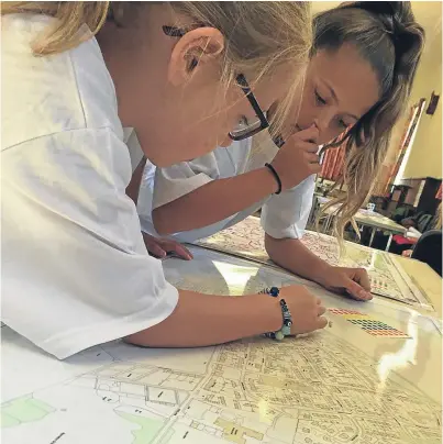  ??  ?? Schoolchil­dren Kirstin Neate and Kristie Wilson look over the plans at the Friockhub open day.