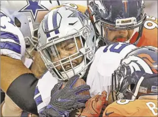  ?? GETTY ?? Ezekiel Elliott played in the first two games of the season, against the Giants and the Broncos (above) and it appears he’ll be playing for the foreseeabl­e future.