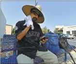  ?? JOSE CARLOS FAJARDO — STAFF PHOTOGRAPH­ER ?? Virginio Rivera, of Pittsburg, wipes his face Friday while waiting at a bus stop in Antioch, where the temperatur­e hit 104in what is typically one of the Bay Area’s hot spots.