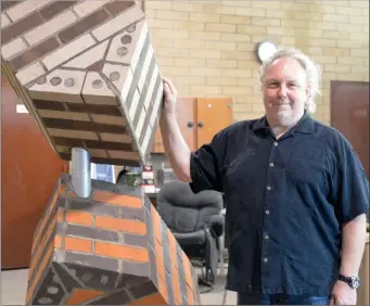  ?? NEWS PHOTO MO CRANKER ?? Artist Robert Harrison, who now lives in Montana, stands with a sculpture he made over the course of two and a half weeks for Medalta out of I-XL bricks. Harrison, alongside Ulla Viotti and Fritz Vehring, created sculptures that Medalta will showcase...