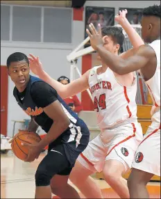  ?? ANDY LAVALLEY/POST-TRIBUNE ?? West Side’s Quimari Peterson, left, looks to make a pass as Munster players collapse on him during their game in Munster on Friday.