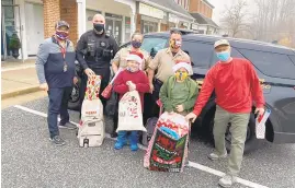  ?? COURTESY PHOTOS ?? Police, firefighte­rs and sheriffs from Annapolis, Anne Arundel County and the state of Maryland volunteere­d their time to deliver gifts to 35 local children.