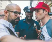  ?? AP/MARY ALTAFFER ?? A police officer separates a pro-Trump supporter (right), who was taunting one of the organizers of the “100 Days of Failure” protest and march, and the organizer Saturday in New York. Thousands of people across the U.S. marked President Donald Trump’s 100th day in office by marching in protest of his environmen­tal policies.