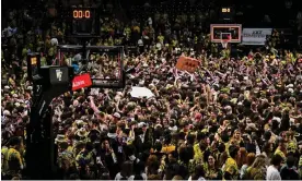  ?? Photograph: Grant Halverson/Getty Images ?? Wake Forest Demon Deacons fans storm the court after upsetting the Duke Blue Devils at Lawrence Joel Veterans Memorial Coliseum on Saturday in Winston Salem, North Carolina.