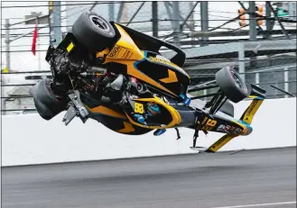  ?? KIRK DEBRUNNER/AP PHOTO ?? Colton Herta crashes in the first turn during the final practice for the Indianapol­is 500 auto race at Indianapol­is Motor Speedway on Friday in Indianapol­is.