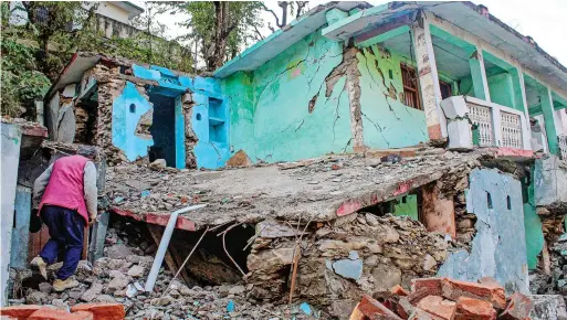  ?? ?? A collapsed portion of a house at Maroda village in Rudraparya­g district. The tunnel constructi­on of Rishikesh-karnapraya­g rail line is suspected to be the reason for these cracks. — pti