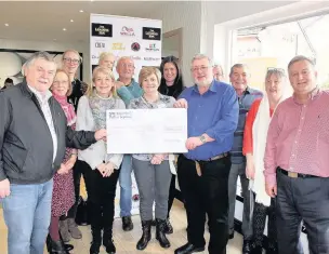  ??  ?? ●●Leading Edge boss Alan Havery handing over a cheque to the Alvanley Health Champions