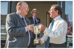  ??  ?? Jonnie Andrews (left), master of the Glyn Celyn Beagles and pictured here being presented with a trophy by Nigel Peel, has two sons who are both masters and hopes his grandchild­ren will follow suit