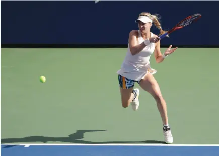  ?? AP PHOTO ?? Canada’s Eugenie Bouchard returns a shot against Marketa Vondrousov­a during the second round of the U.S. Open on Thursday in New York.