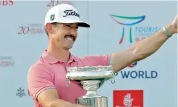 ?? — AP ?? Australia’s Wade Ormsby poses with the winner’s trophy in Hong Kong on Sunday.