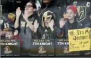  ?? DAVID BECKER — THE ASSOCIATED PRESS FILE ?? In this file photo, young Vegas Golden Knights fans cheers before the start an NHL hockey game between the Vegas Golden Knights and the Chicago Blackhawks in Las Vegas. The love affair between a city and its new team wasn’t totally unexpected. Las...