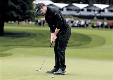  ?? Justin Lane EPA/Shuttersto­ck ?? EX-UCLA STAR Patrick Cantlay, putting on the first hole of the final round, finished in a tie for third with Jordan Spieth and Matt Wallace at two-under 278. He finished in a tie for ninth at the Masters last month.