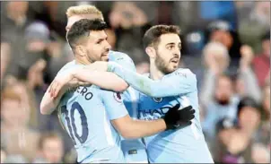  ?? PAUL ELLIS/AFP ?? Manchester City striker Sergio Aguero (left) celebrates with teammates after scoring his side’s fourth in their league match with Leicester City on Saturday.