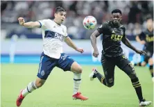  ?? THE CANADIAN PRESS ?? Vancouver Whitecaps’ Brian White, left, and Los Angeles FC’s Jesus David Murillo vie for the ball.