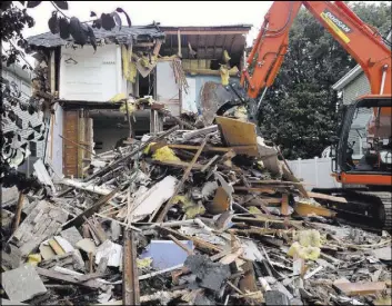  ??  ?? Jamilyn Spellman’s home ravaged by Superstorm Sandy is torn down July 14, 2014.