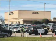  ?? Juan Figueroa / Dallas Morning News ?? Police vehicles surround the West Freeway Church of Christ in White Settlement, Texas. A gunman fatally shot two people before he was killed.