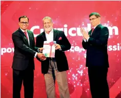  ??  ?? The first copy of the Curriculum 2020 being presented to Chief Guest Mr. Rajendra Theagaraja­h, Managing Director/CEO of Cargills Bank by Chairman of the Curriculum Task Force Mr. Chaaminda Kumarasiri in the presence of CA Sri Lanka President Mr. Jagath Perera.