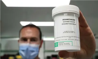  ??  ?? A Belgian pharmacist with a container of Dexamethas­one, a cheap and standard treatment for the sickest Covid patients. Photograph: Yves Herman/Reuters