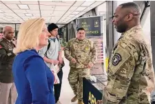  ?? Lolita Baldor/Associated Press ?? Army Secretary Christine Wormuth stops at an Army recruiting display after a speech to students. Army recruiters are struggling to meet enlistment goals and getting back into high schools.