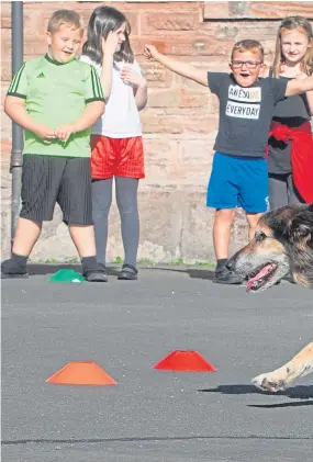  ?? Picture: SWNS. ?? Russell with school children at Coalsnaugh­ton Primary School who love his visits.