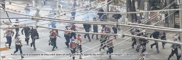  ??  ?? Police charge at protesters as they crack down on demonstrat­ions against the military coup in Yangon. — AFP photos