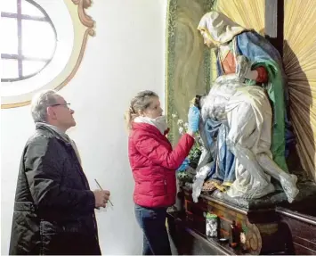  ?? Fotos: Ursula Katharina Balken ?? Die Pietà in der Michaelski­rche wird bald wieder in alter Schönheit erstrahlen. Die Restaurato­ren Sarah Dannhauer und Roland Vogel sind dabei, die unerwünsch­te Goldfarbe zu entfernen.