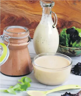  ?? ERIC AKIS ?? Toss your salads with these homemade dressings. Left: raspberry balsamic vinaigrett­e; back, poppy-seed dressing with orange, honey and Dijon; front, coconut sesame ginger.