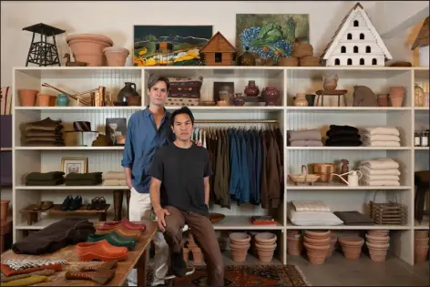  ?? MARCI LEBRUN — THE NEW YORK TIMES ?? Christophe­r Crawford, left, and Alan Calpe at the Gardenheir store they opened last November near their home in Windham, N.Y.