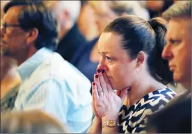  ??  ?? Congregati­on members pray during a service at the First United Methodist Church in Coral Springs, Fla, on Sunday The service was dedicated to the victims of Wednesday’s mass shooting at nearby Marjory Stoneman Douglas High School in Parkland.